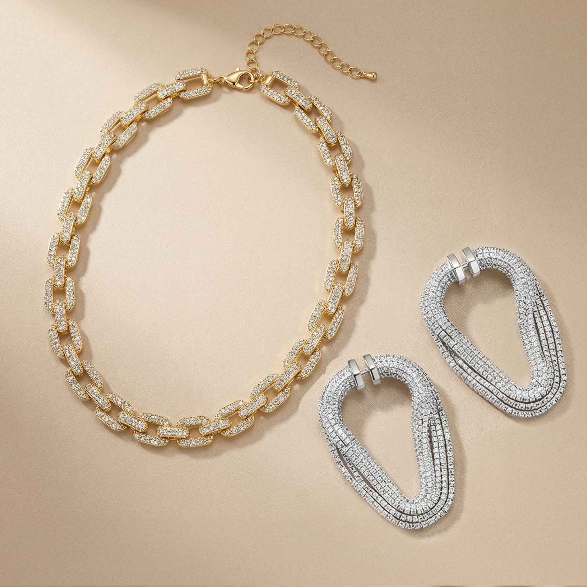Gold and silver chain necklaces on a beige background