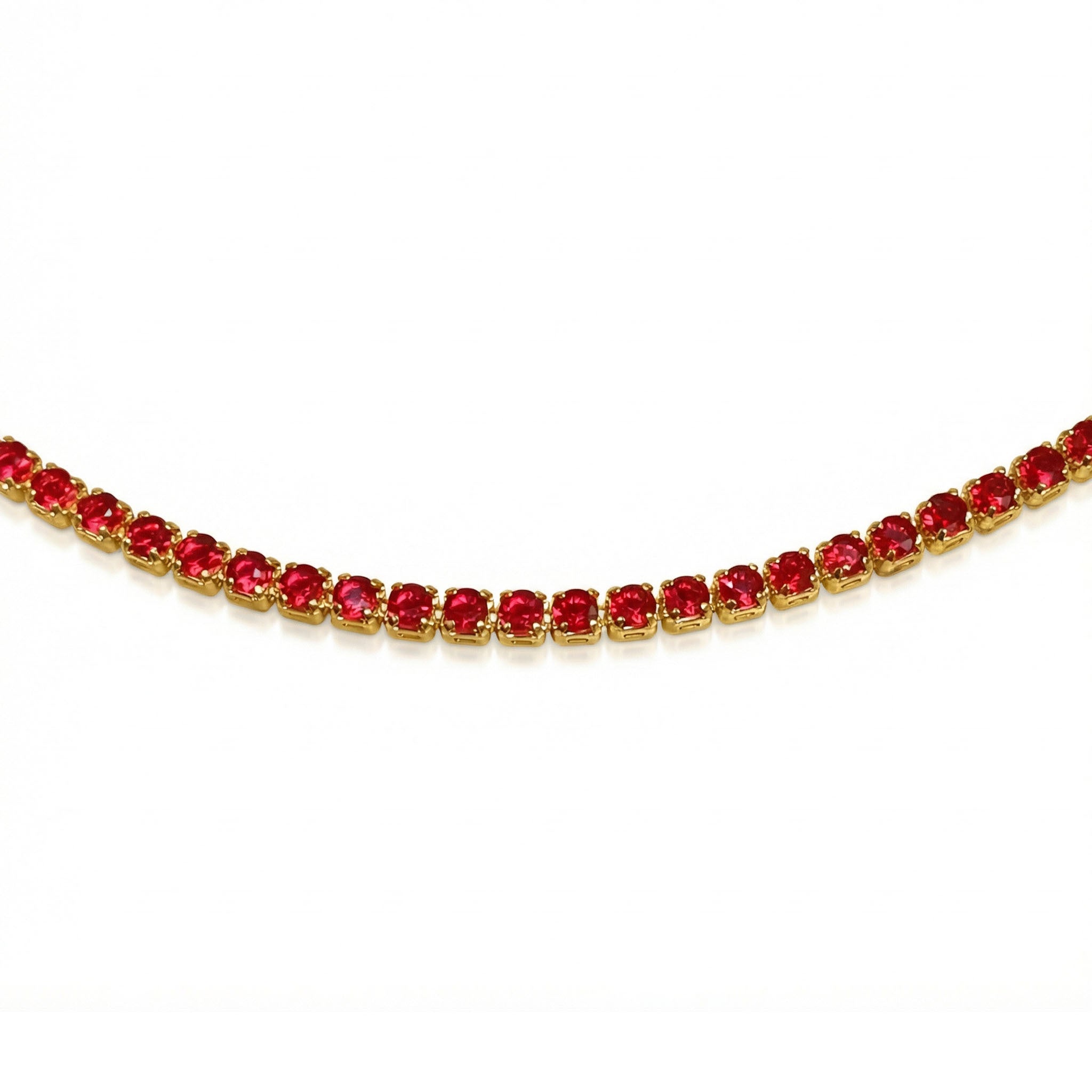 Gold necklace with red gemstones on a white background