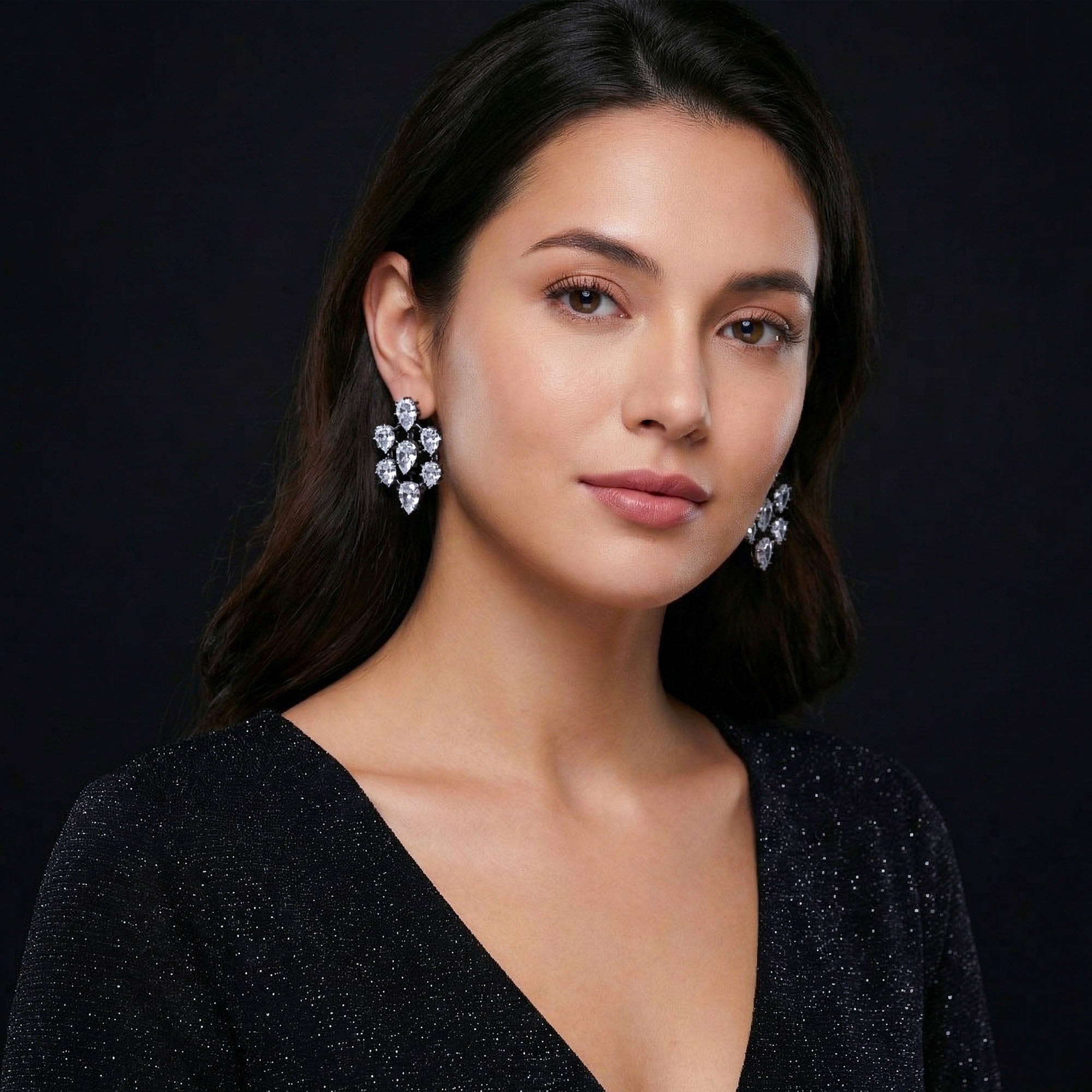 Woman wearing sparkling earrings for women against a dark background