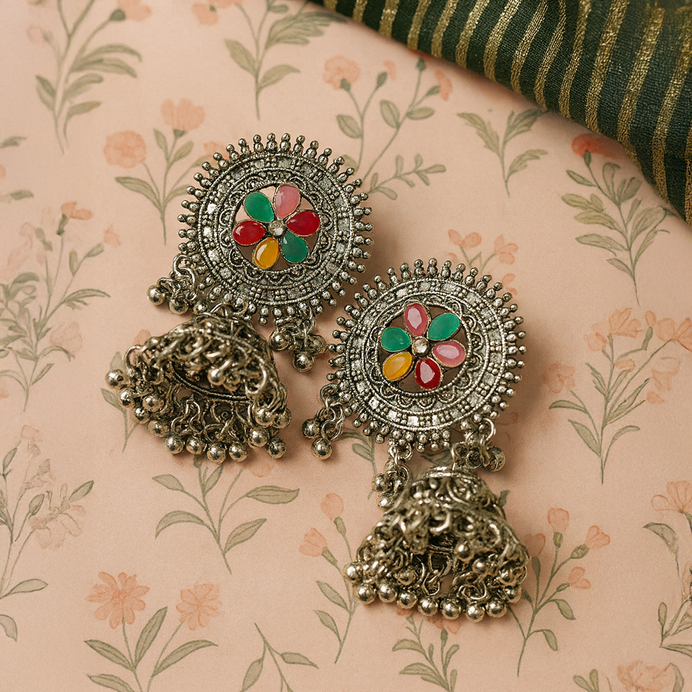  silver earrings for women with colorful stones on a floral-patterned fabric background