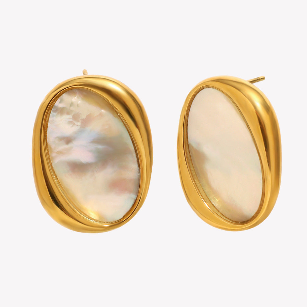 Gold-framed earrings with a light-colored stone on a white background